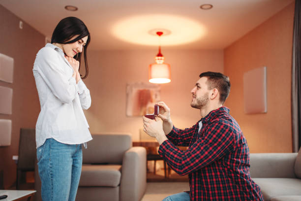 istock Young man makes an offer to surprised woman 953205396