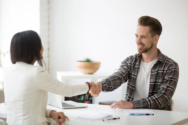 istock Smiling millennial partners handshaking in office thanking for successful teamwork 953210750