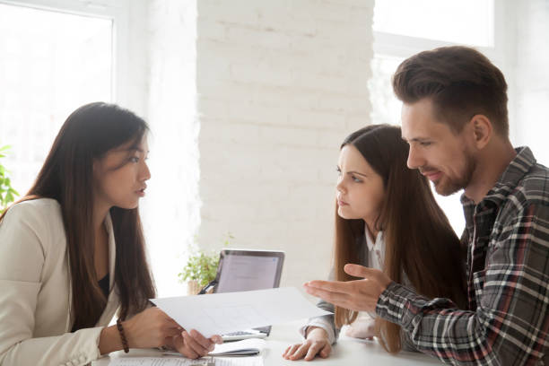 istock Asian lawyer consulting unconvinced deceived clients complaining on bad contract 953210806