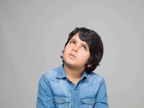 istock Portrait of thinking young boy 953211336
