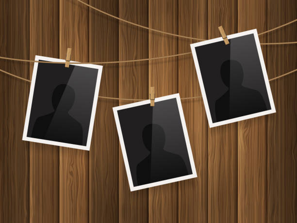 Photo frames fixed on the rope with clothespins on wood background. Vector. Photo frames fixed on the rope with clothespins on wood background. clothespin photos stock illustrations