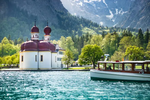 Koenigssee, Bavaria, Germany. The church of St. Bartholomae on a peninsula in the middle of the Koenigssee is one of the landmarks and excursion destinations of Berchtesgaden. The view of St. Bartholomae with Koenigssee and Watzmann Ostwand is world-famous.