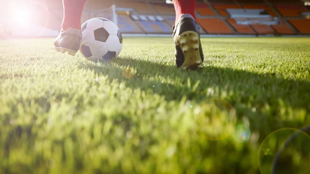 istock Low Section Of Man Playing Soccer At Stadium On Sunny Day 953222848