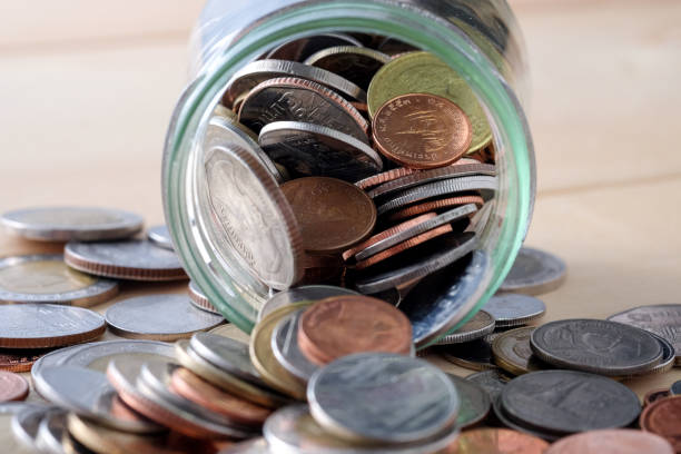 istock Close-Up Of Coins In Jar On Table 953227310