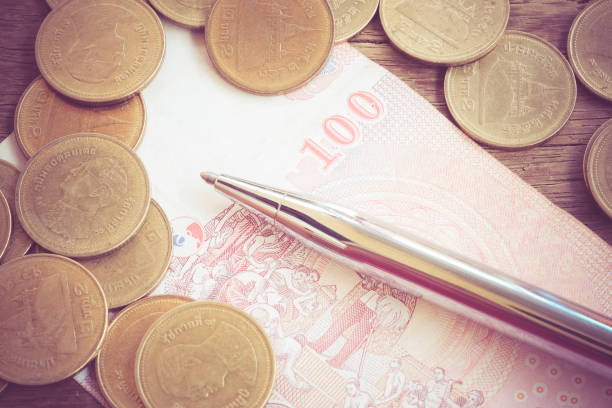 istock Close-Up Of Money With Pen On Table 953230156