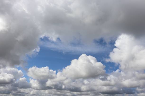 istock Close up of fluffy white clouds in blue sky 953232544