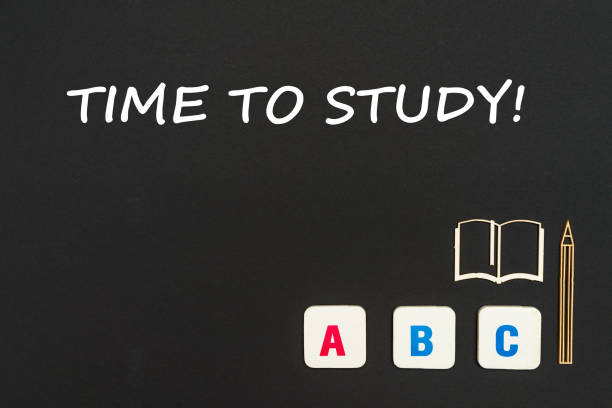 istock abc letters and chipboard miniature on blackboard with text time to study 953236370