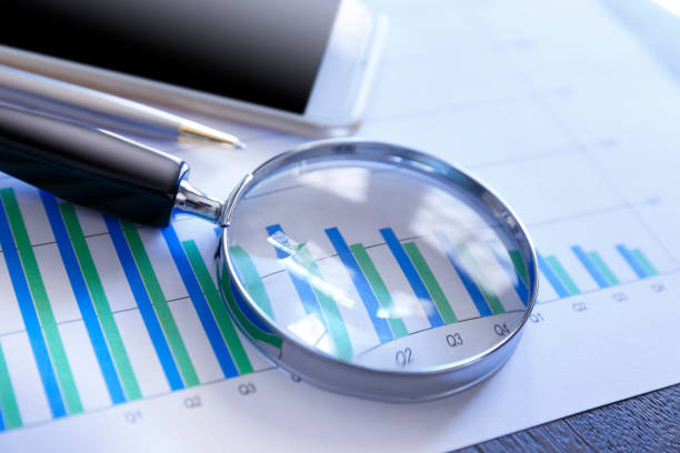 istock Magnifying Glass On Top Of Bar Chart Showing Decling Performance 953236706