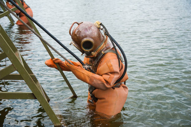 Diver immerses in a copper old vintage deep sea diving suit