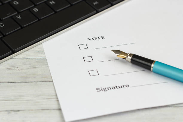 istock Pen for writing on a wooden table with a document for a signature 953240706