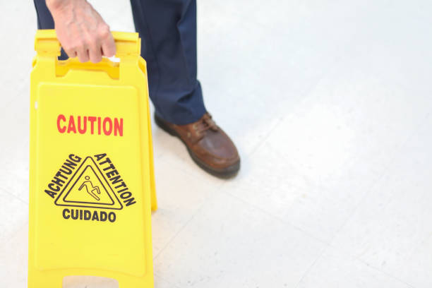 istock Unrecognizable male janitor mopping floor in office building. 953243076