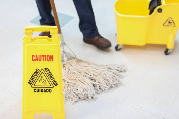 istock Unrecognizable male janitor mopping floor in office building. 953243168