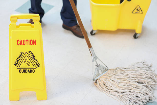 istock Unrecognizable male janitor mopping floor in office building. 953243172