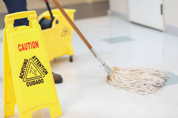 istock Unrecognizable male janitor mopping floor in office building. 953243256