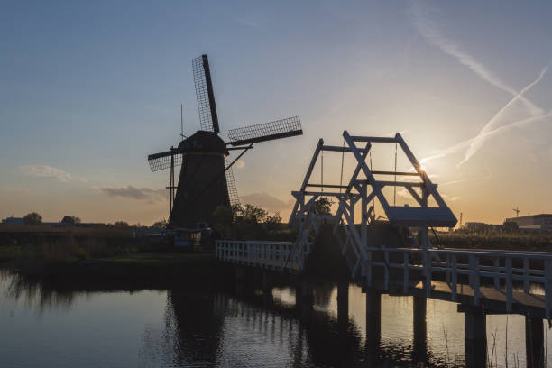 Kinderdijk Molenwaard South Holland The Netherlands Europe Sunset on windmill reflected in the canal lek river in the netherlands stock pictures, royalty-free photos & images