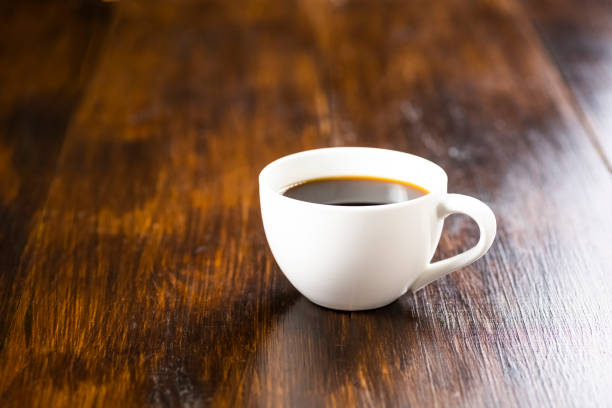 istock a cup of black coffee on a wooden table, 953243862