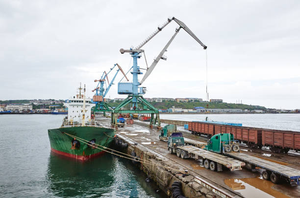 istock Port, cargo ship, sea, crane, pier, gray cloudy sky 953247328