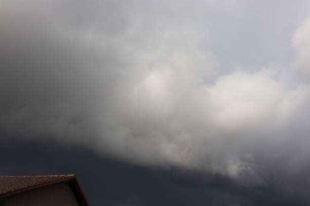 istock Overcast sky with dark clouds over house roof with tiles 953248974
