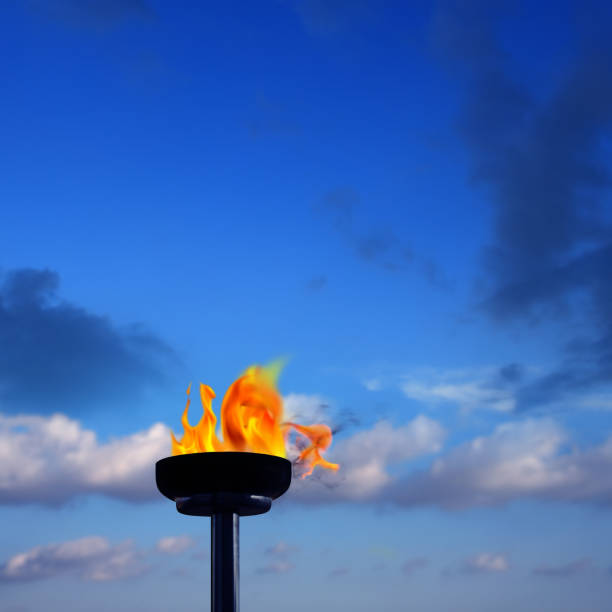 istock Close up burning flaming torch over cloudy blue sky 953251268