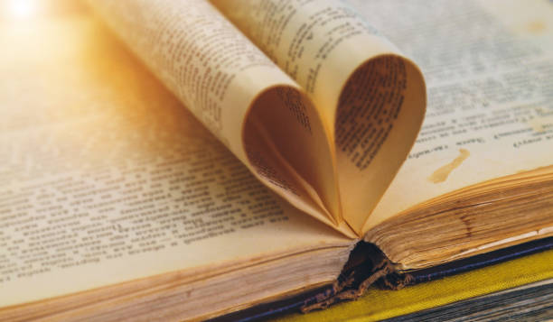 istock an open old book with sheets in the shape of a heart 953251478