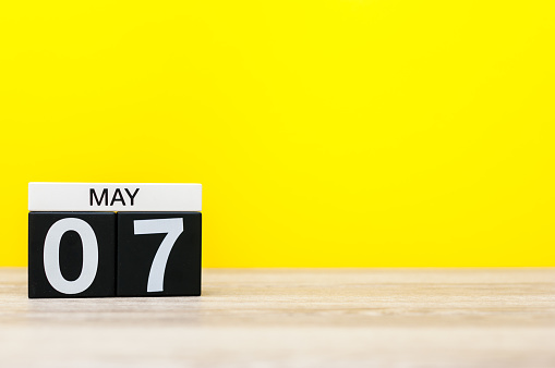 May 7th. Day 7 of may month, calendar on yellow background. Spring time, empty space for text.