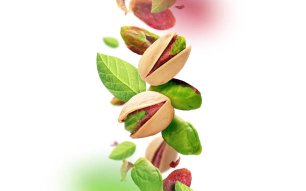 Pistachios and leaves falling from the air stock photo