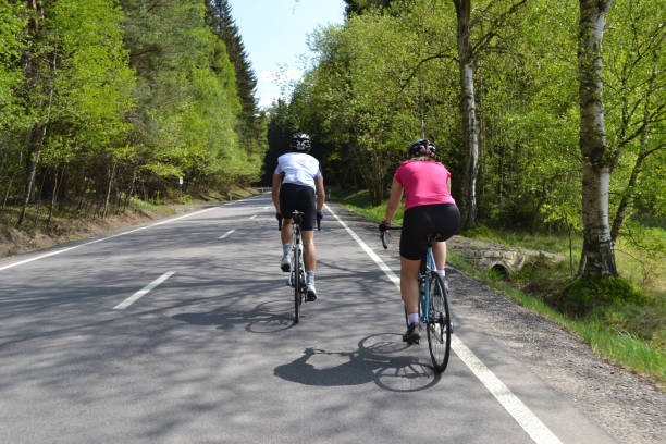 istock Spring bike riding through tree avenue 953256974