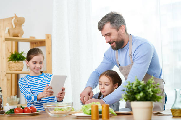 istock Helping Little Daughters to Prepare Salad 953260432