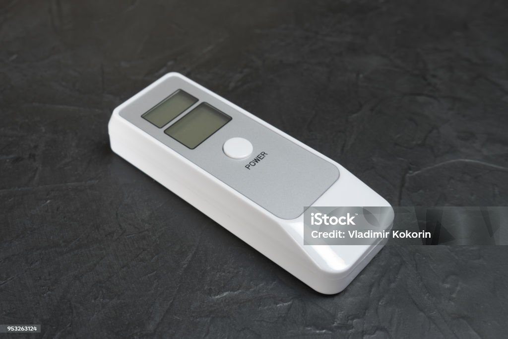 Device for measuring the degree of intoxication. Device for measuring the degree of intoxication... Alcohol - Drink Stock Photo