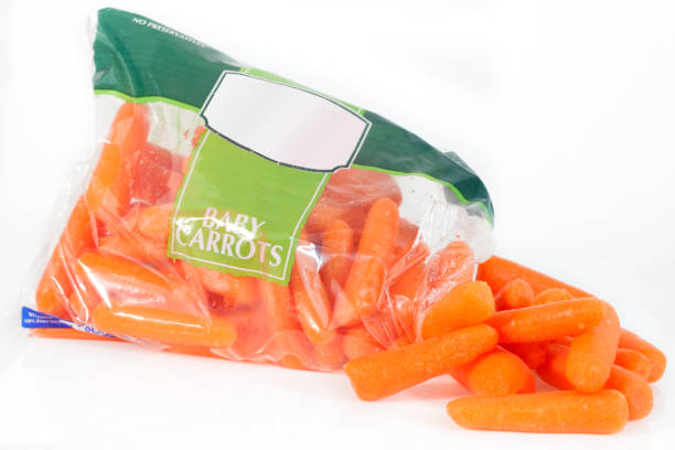 istock Baby Carrots Spilling from Bag 953264142