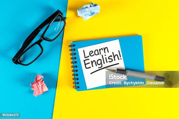 Learn English Note At Blue And Yellow Background With Teachers Glasses Stock Photo - Download Image Now