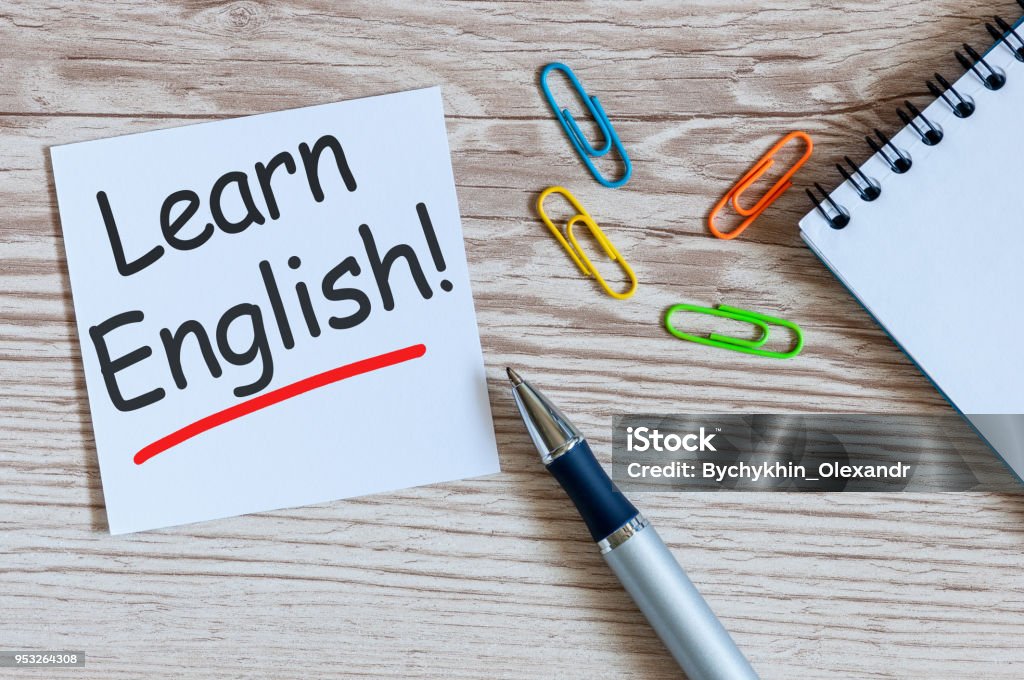 Learn english - note at wooden background with teachers glasses Learn english - note at wooden background with teachers glasses. English Language Stock Photo