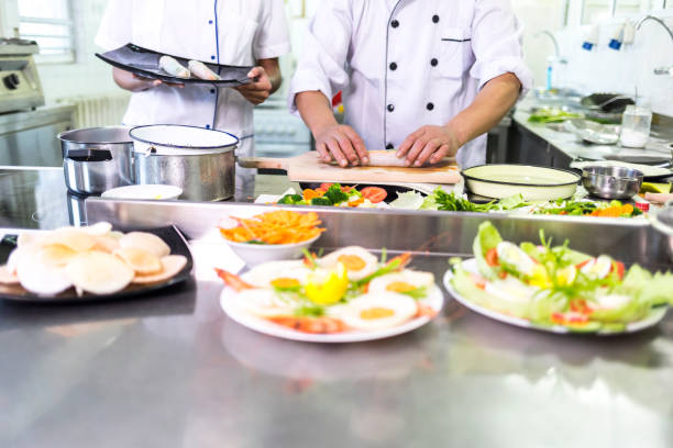 istock Senior chef and assistant preparing spring rolls in asian restaurant 953267640