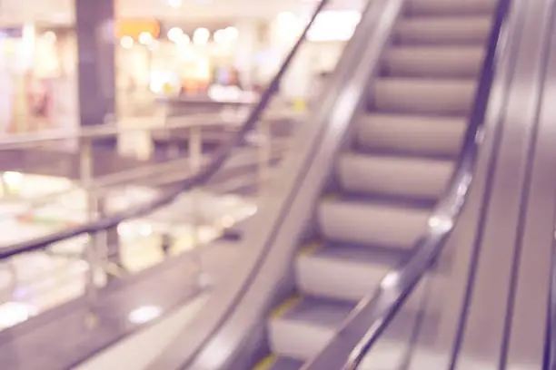 Shopping center. Blurred background. Gray escalator.