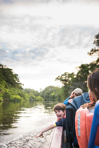 Family plays along the Amazon river in the jungle of Ecuador