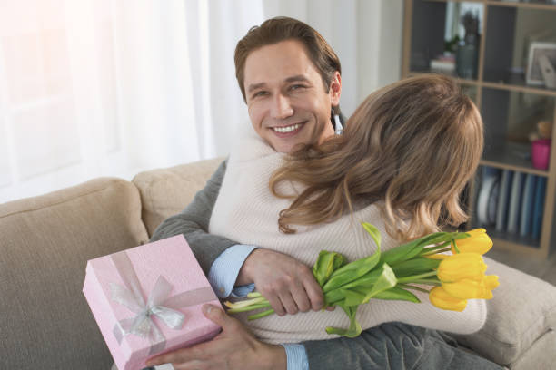 istock Beaming man hugging woman in room 953268324