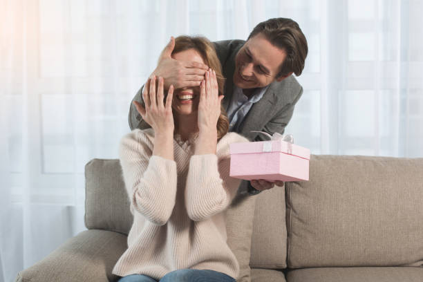 istock Glad husband giving gift to outgoing wife 953268446