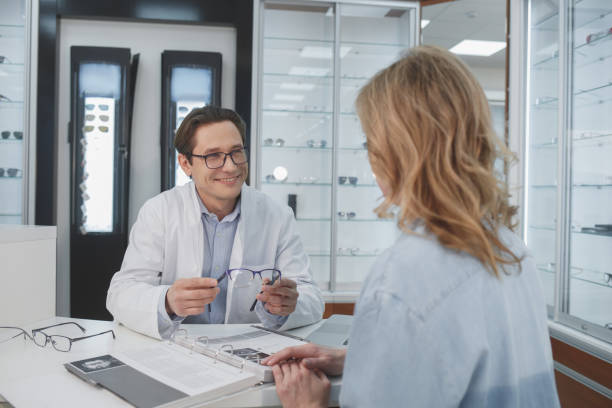 istock Happy doctor talking with client at desk 953268632