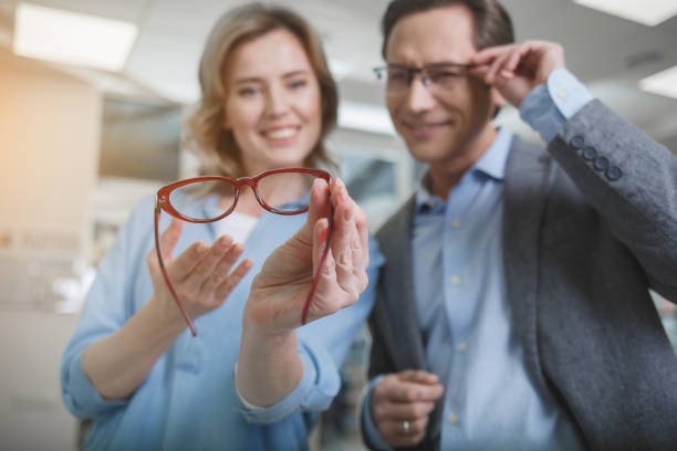 istock Beaming watching at spectacles in optician shop 953269194