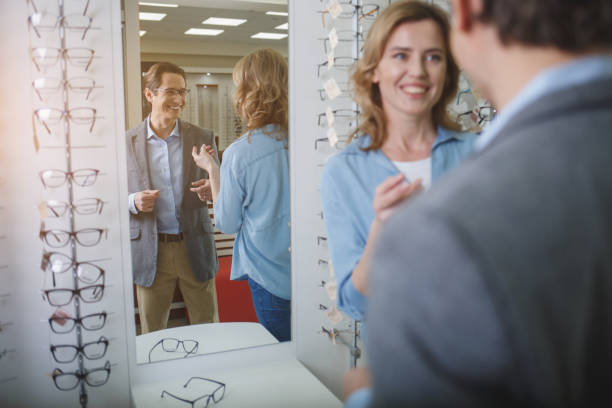 istock Beaming couple speaking in optician shop 953269228