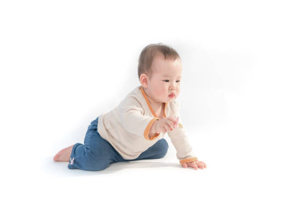 istock Cute baby sitting playing with color models in white background 953280822