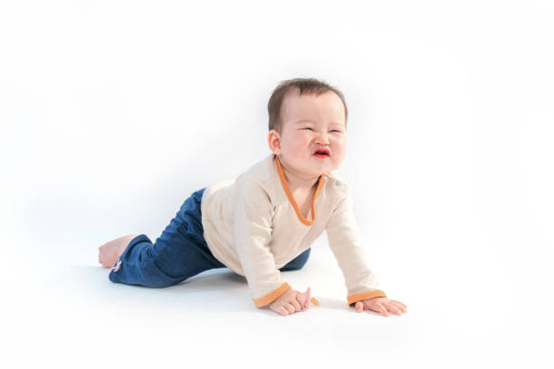 istock Cute baby sitting playing with color models in white background 953281328