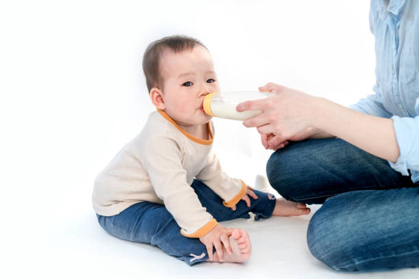 istock Mother is feeding the baby, white background 953282076
