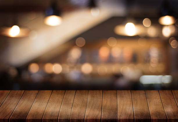 istock Wooden board empty table  cafe, coffee shop, bar blurred background can be used for display or montage your products and Mock up 953286416