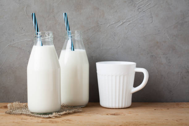 istock Two bottles of milk on dark background with copy space 953291078
