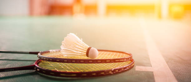 istock Badminton ball (shuttlecock) and racket on court floor 953295296