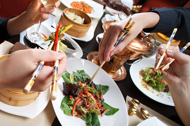 istock People eating with chopsticks out at an Asian restaurant 95331448