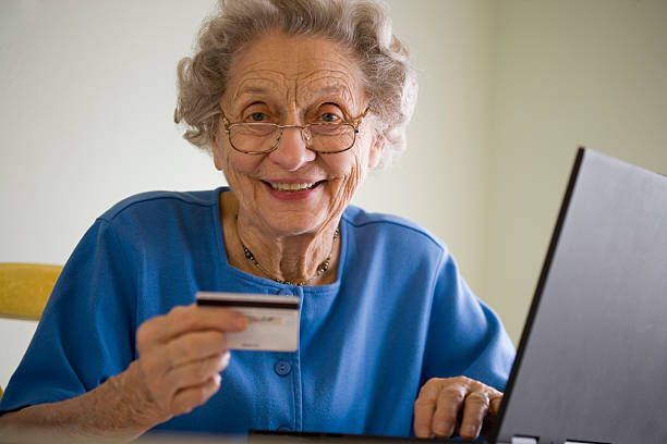 Elderly woman doing online shopping stock photo