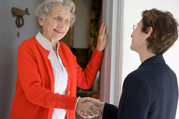 Senior woman at front door