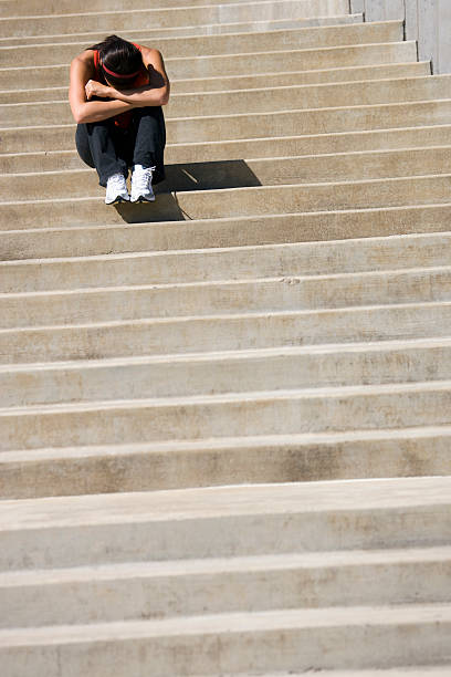 istock Depressed woman sitting on steps 95340008